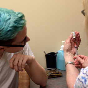 Many transgender people face discrimination in health care. Here, Cole Young prepares to receive an injection of testosterone. Photo by Jaime Kedrowski/Columbia Missourian.